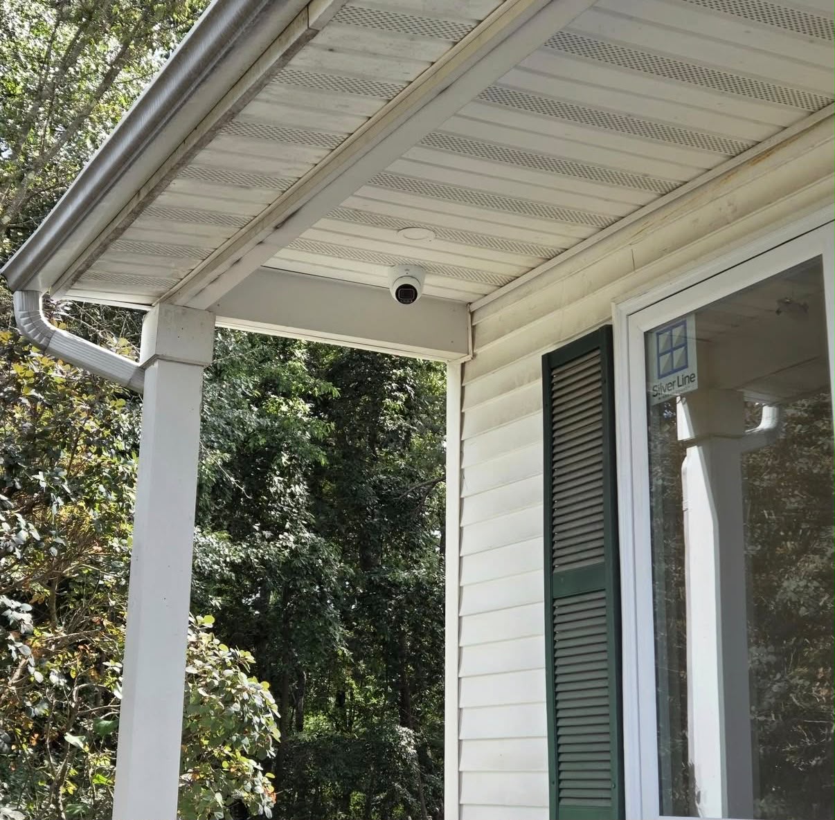 Dome security camera mounted under a porch ceiling